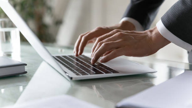 istock Close up businessman using laptop in office, typing on keyboard 1314304189