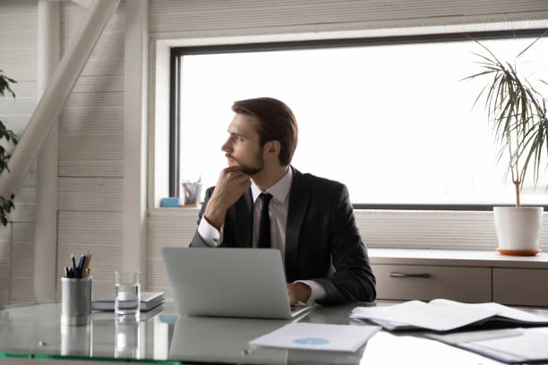 istock Thoughtful businessman touching chin, looking to aside, pondering task 1314304214