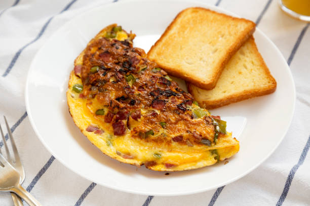 istock Homemade Denver Omelette on a white plate on cloth, side view. Flat lay, top view, from above. 1314306486