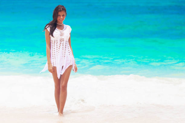 istock Happy woman walking on beach 1314306613