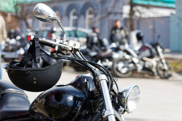 istock Closeup black moto helmet on motorcycle handlebars against blurred background 1314306963