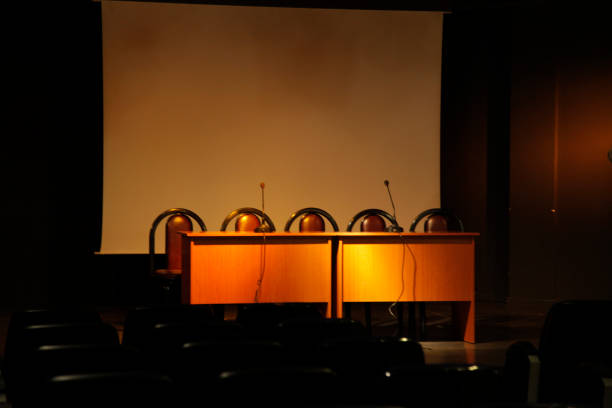 Empty Press conference, lecture desk,interview event, meeting A panel discussion with microphones and chairs for interview event, meeting, Press conference, lecture shareholders meeting stock pictures, royalty-free photos & images