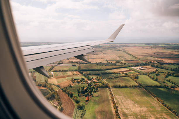 istock View from the airplane window of the fields and green meadows below 1314311987