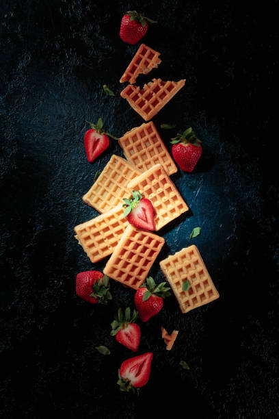 istock Waffles with fresh juicy strawberries on a dark blue background. 1314314104