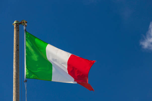 istock Italian flag blowing in the wind in the blue sky 1314314842