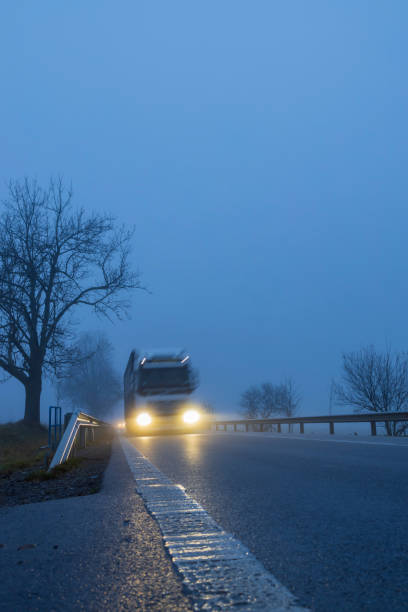 istock Lighted cars at dusk on  main road 1314314870