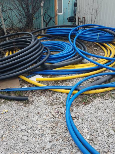 istock Black, yellow and blue flexible pipes lying on the ground. 1314316115