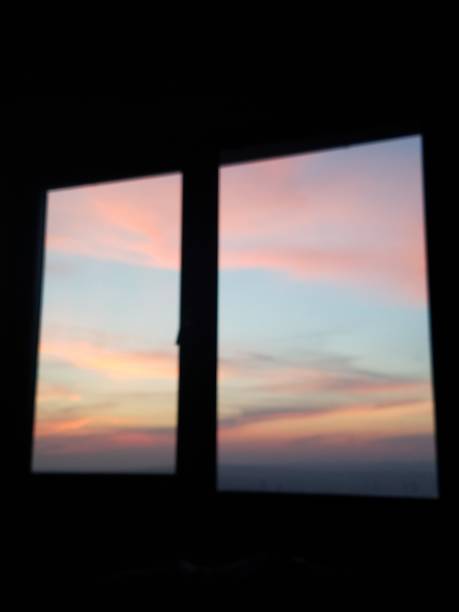istock Beautiful sunset colors seen from inside a dark room window. 1314316137
