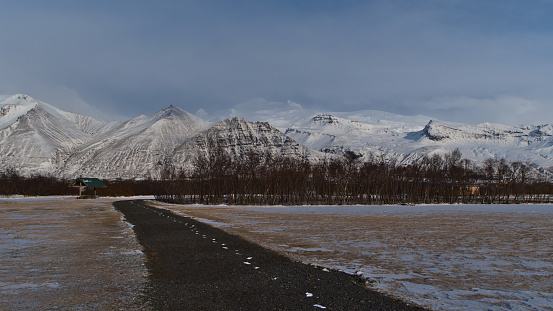 Empty camping area in Skaftafell national park, southern Iceland in winter season with the majestic ice-capped mountains of Öræfajökull volcano, including Hvannadalshnúkur peak (2110m).
