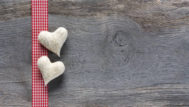 istock White hearts on wooden background 1314318554