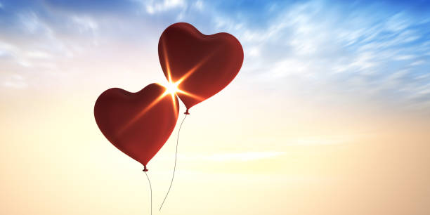 istock Two Balloons Flying to the blue sky with sunlight 1314319665