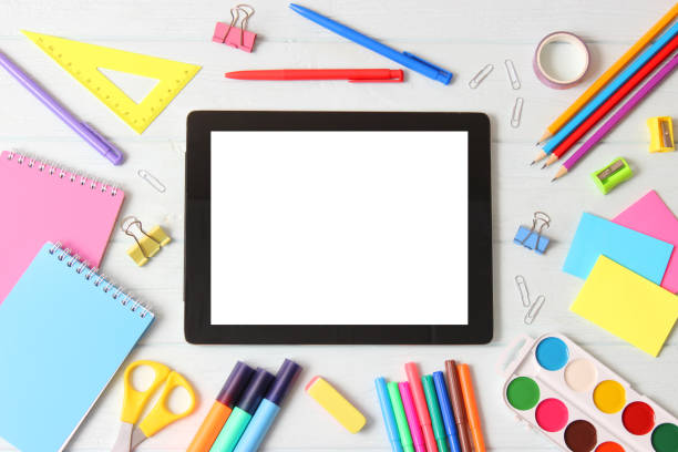 istock Modern digital tablet and school stationery on a colored background top view. 1314323717