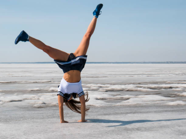istock A beautiful woman with a slim attractive tanned body performs acrobatic tricks on the ice 1314323721