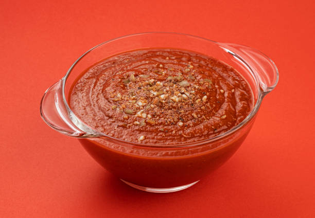 istock Bowl of tomato soup isolated on red background 1314324769