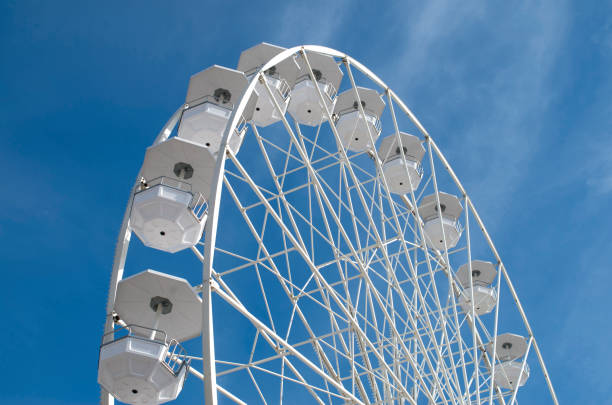 istock White Ferris wheel in the blue sky  with clouds 1314325523