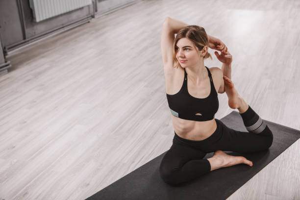 istock Woman doing yoga at sport studio 1314326681