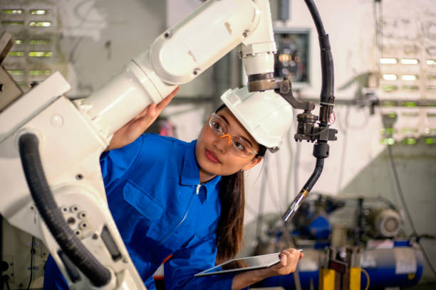 istock Woman mechanic repairing a robot machine. 1314326724