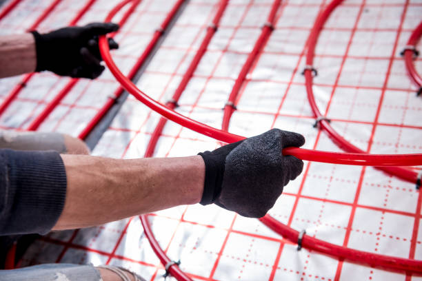 istock Pipefitter install system of underfloor heating system at home 1314327776