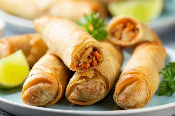 istock Fried spring rolls with sweet chili sauce and lime on plate 1314327942