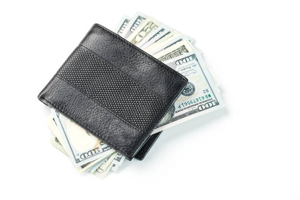 istock Black wallet with genuine leather dollars on an isolated white background. 1314330840
