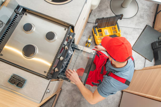 istock RV Technician Replacing Broken Travel Trailer Gas Stove 1314332138