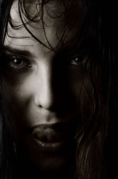 istock Black and white photo of a witch licking her lips 1314332256