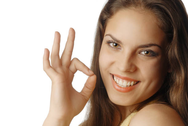istock Beautiful smiling model showing OK gesture 1314332384