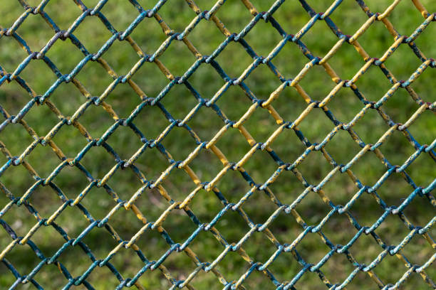 istock Multicolored metal wire mesh. Fenced field. 1314333358