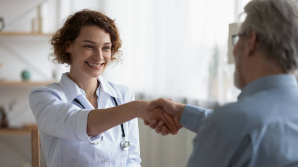 istock Happy 35s young female physician shaking hands with patient. 1314334466