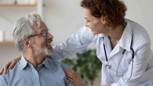 istock Smiling kind female general practitioner embracing shoulders of elderly patient. 1314334483