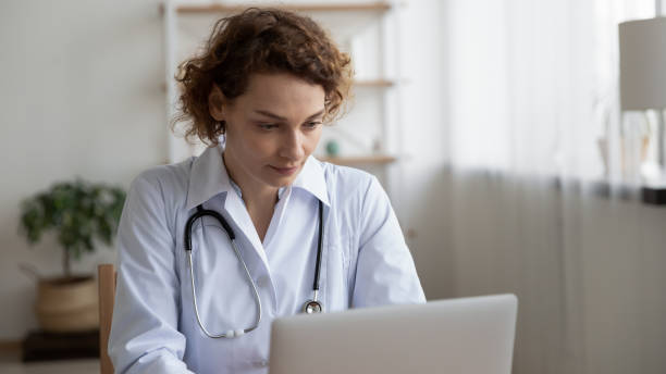 istock Focused young female 35s doctor working on computer. 1314334494