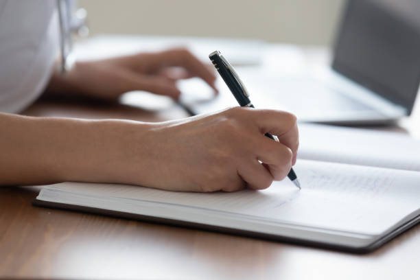 istock Close up young female medical worker handwriting notes. 1314334506