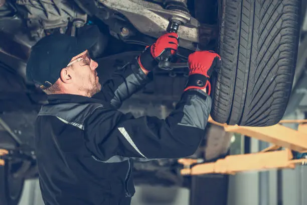 Photo of Automotive Mechanic Replacing Car Suspension Elements