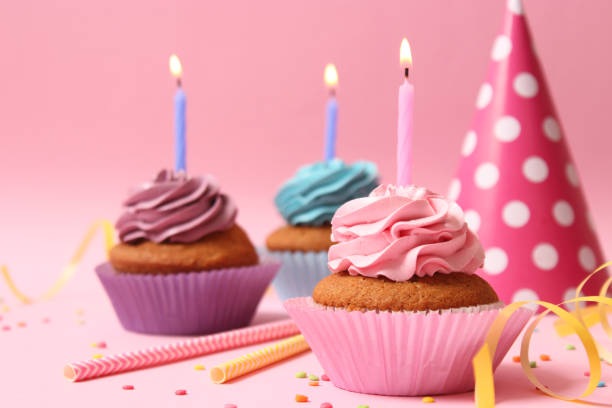 istock Delicious cupcake with a candle on a colored background 1314335765