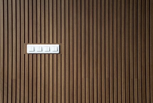 Full frame shot of wooden planks as a wall background with light buttons