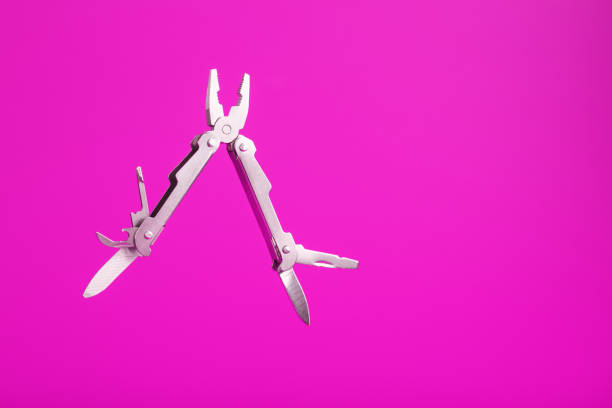 istock Multitool is a multi-functional tool on a pink background. The concept of an open, flying multi-tool with free space. 1314336229