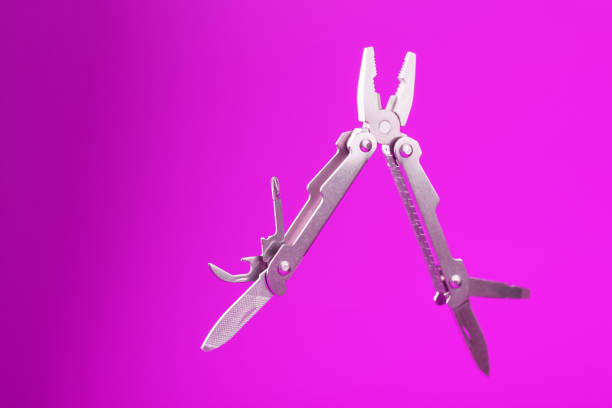 istock Multitool is a multi-functional tool on a pink background. The concept of an open, flying multi-tool with free space. 1314336266