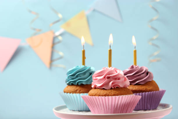 istock Delicious cupcake with a candle on a colored background with space for text. 1314337349