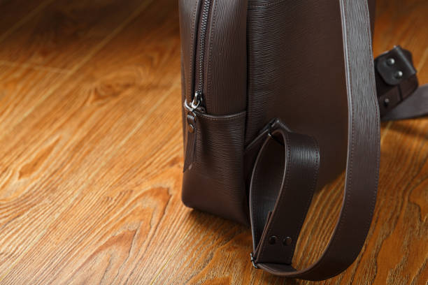 istock Backpack made of brown genuine leather on a wooden background. 1314337891
