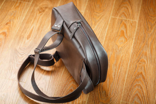 istock Backpack made of brown genuine leather on a wooden background. 1314338720