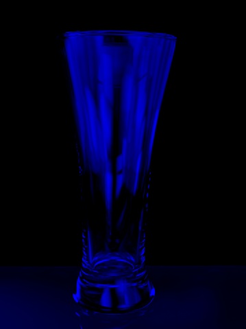 Pilsner beer glasses light painted using a composite imagery technique. Blue illumination.