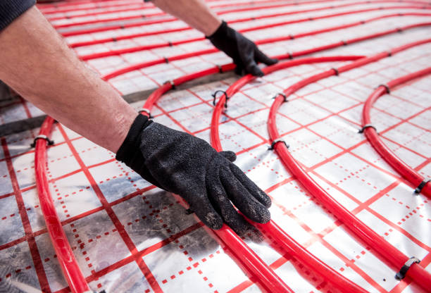 istock Pipefitter install system of underfloor heating system at home 1314340381