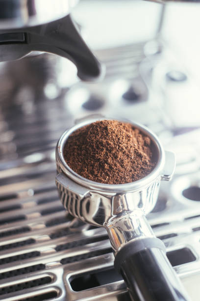 istock Coffee beans in a portafilter by the coffee grinder 1314341815