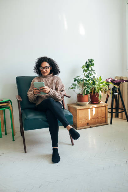 istock Working from Home: a Young Woman Using a Digital Tablet to ReadWatch Something (Copy Space) 1314341953
