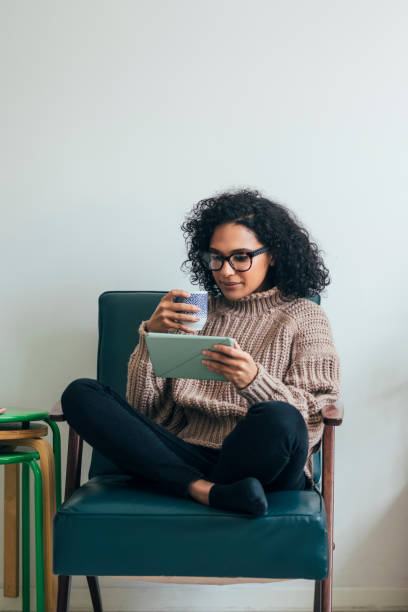 istock Working from Home: a Young Woman Using a Digital Tablet to ReadWatch Something (Copy Space) 1314341961