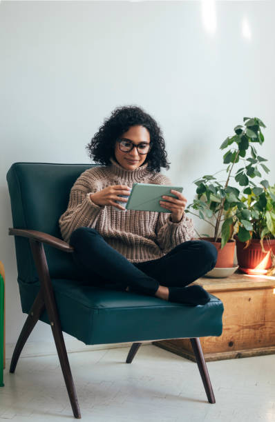 istock Working from Home: a Young Woman Using a Digital Tablet to ReadWatch Something (Copy Space) 1314341965