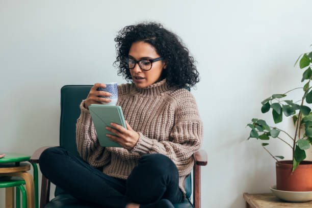 istock Working from Home: a Young Woman Using a Digital Tablet to ReadWatch Something (Copy Space) 1314341979