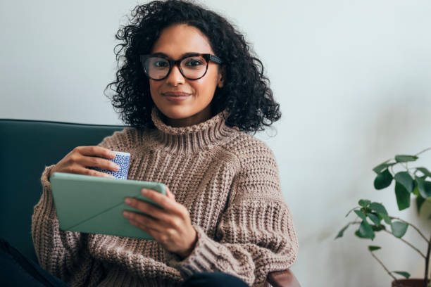 istock Working from Home: a Young Woman Using a Digital Tablet to ReadWatch Something (Copy Space) 1314341981