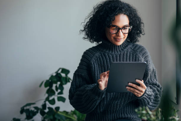istock Working from Home: a Young Woman Using a Digital Tablet to ReadWatch Something (Horizontal) 1314341989