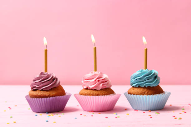istock Delicious cupcake with a candle on a colored background 1314342718
